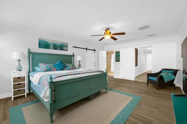 a bedroom with a bed and a chandelier