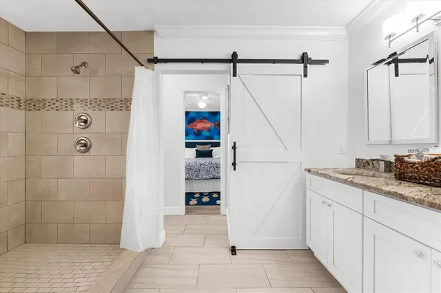 a bathroom with a granite countertop shower a sink and a toilet