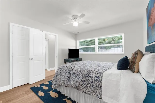 a bedroom with a bed and wooden floor
