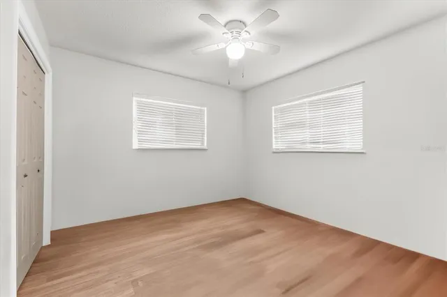 a view of an empty room with a floor to ceiling window and yard