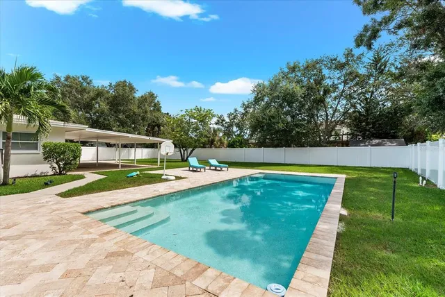 a view of a swimming pool with a patio