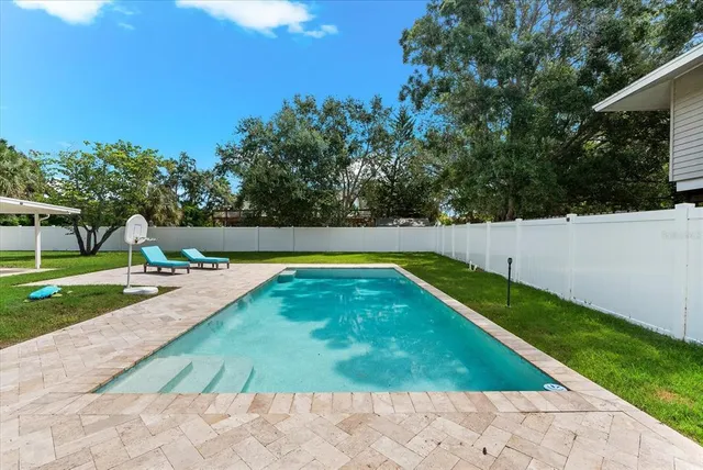 a view of yard with swimming pool and green space