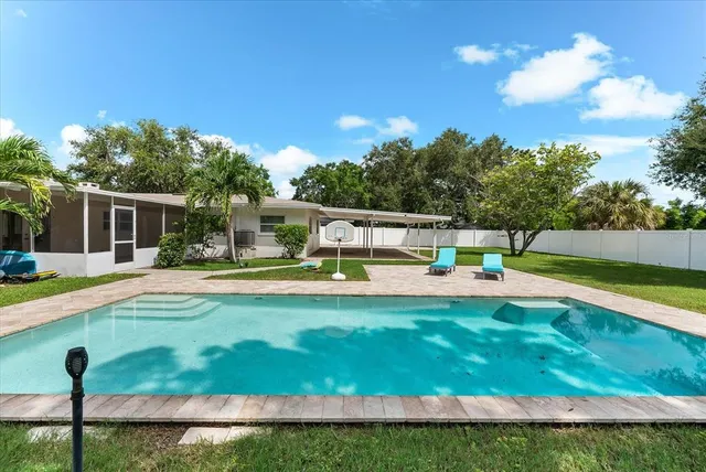 a view of a house with backyard and sitting area