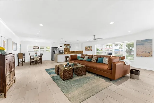 a living room with furniture and a view of kitchen