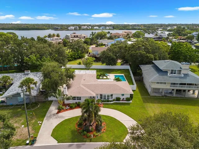 an aerial view of a city with lots of residential buildings lake and ocean view