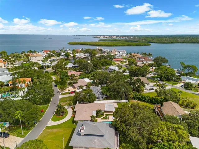 an aerial view of a house with swimming pool and garden