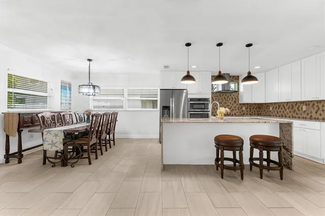a dinning area with furniture and kitchen view