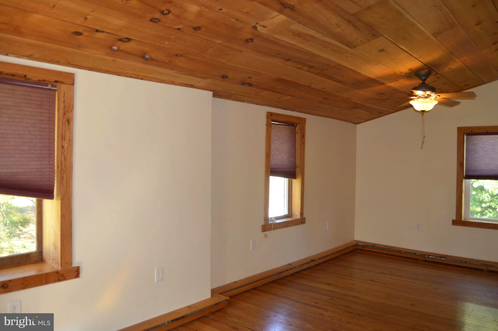 1160 Jack Road Orrtanna, PA 17353 - Photo 14 of 21 Bedroom 1 - wood floors, ornamental fireplace