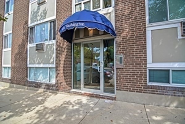 461 Washington Street, Unit 301 Boston, MA 02135 - Photo 1 of 14 a front view of a house with glass windows