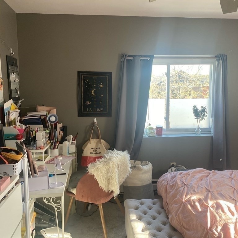 461 Washington Street, Unit 301 Boston, MA 02135 - Photo 12 of 14 a bed room with a bed and a chair