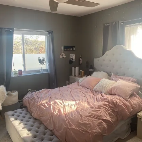 a bedroom with a bed and window