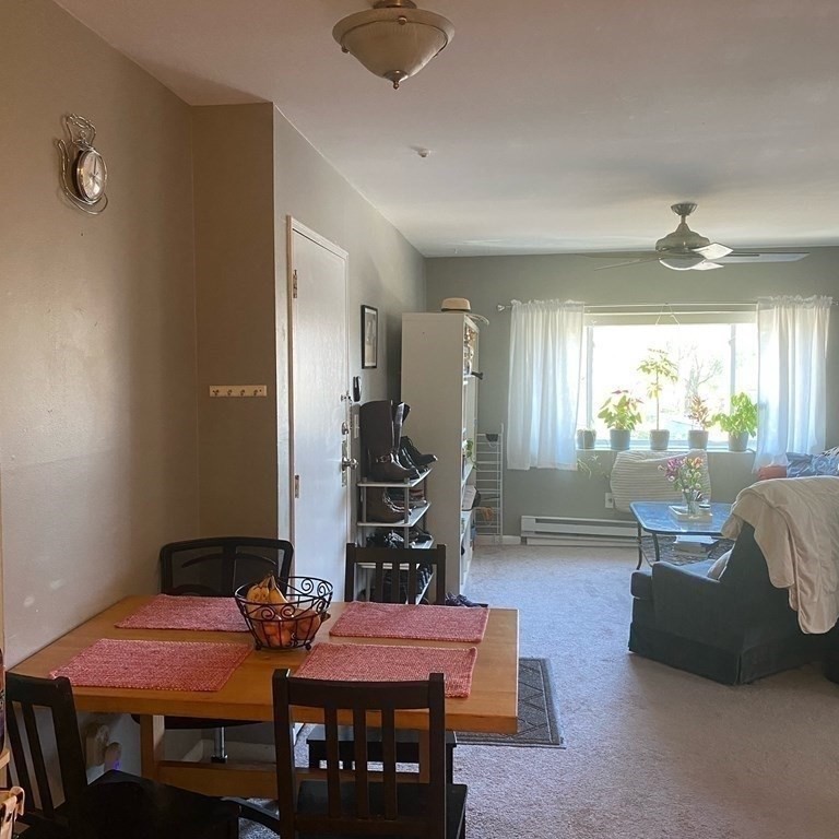 461 Washington Street, Unit 301 Boston, MA 02135 - Photo 4 of 14 a view of a dining room with furniture and wooden floor