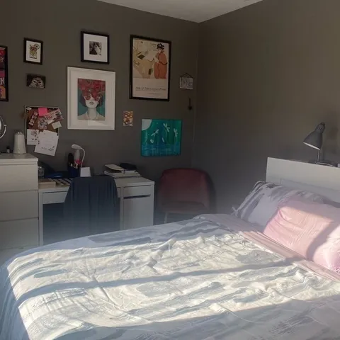 a bedroom with a bed and a table