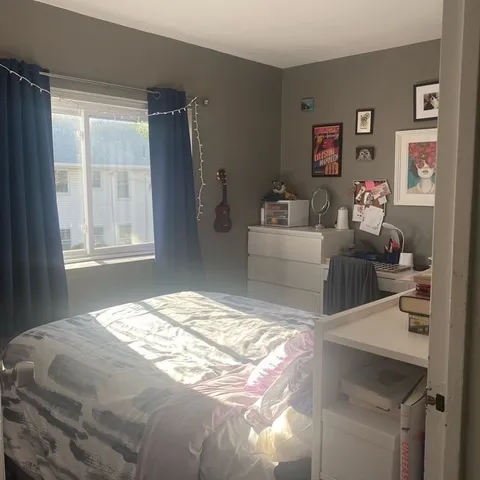 a bedroom with a bed and a couch
