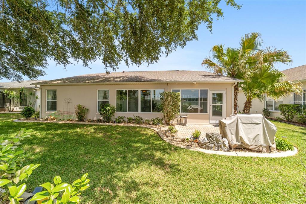 16369 Southwest 14th Avenue Road Ocala, FL 34473 - Photo 45 of 49 a view of a house with backyard sitting area and garden