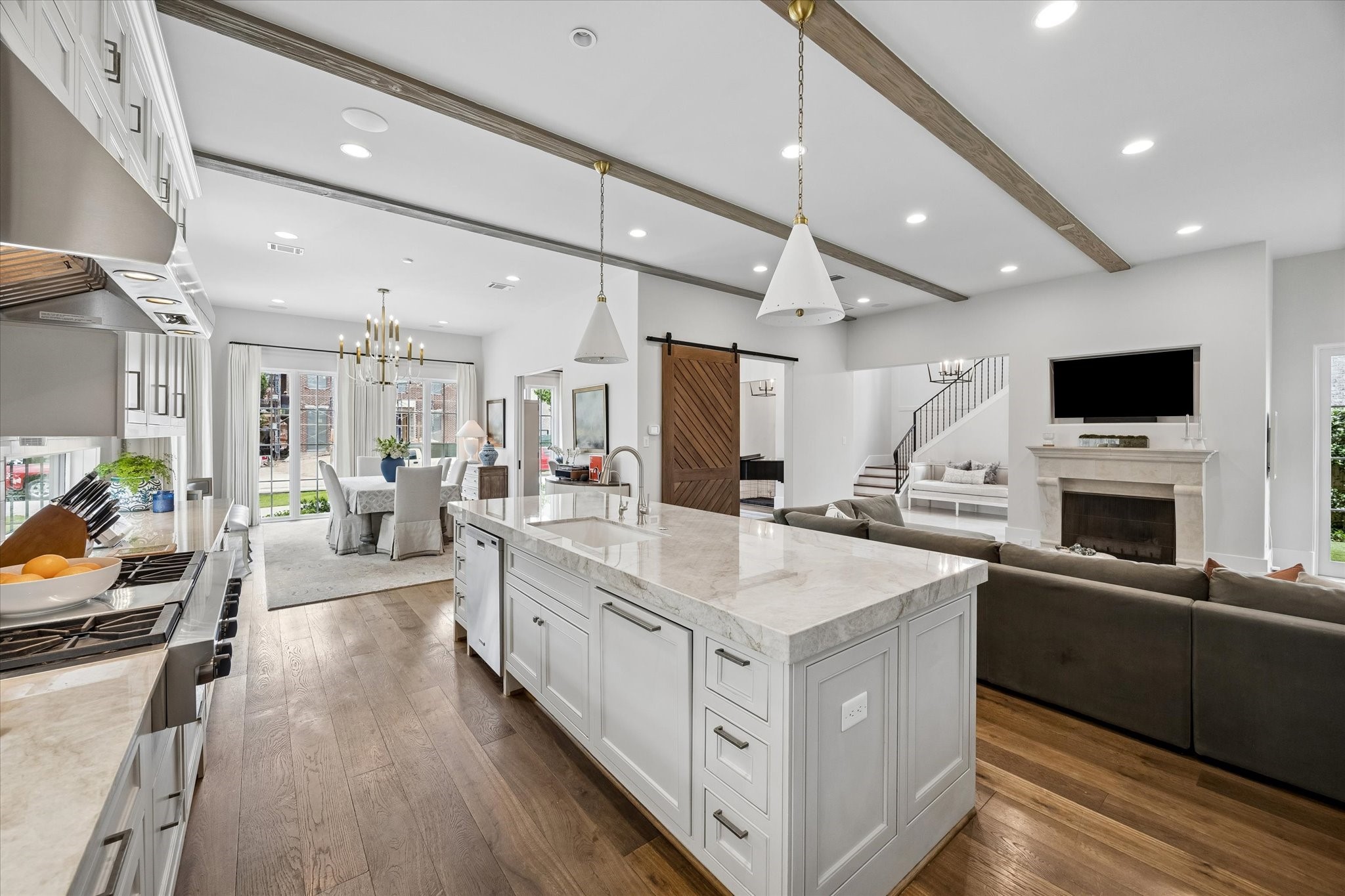 3615 Overbrook Lane Houston, TX 77027 - Photo 11 of 34 a large white kitchen with a large island in the center
