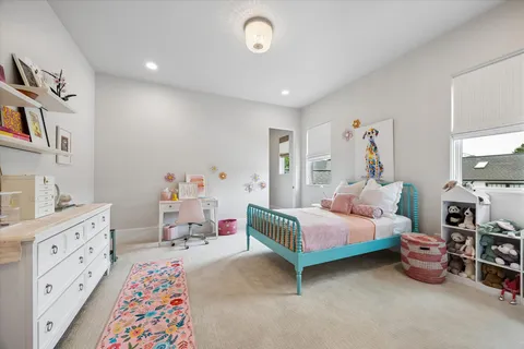 a bedroom with furniture and a baby crib