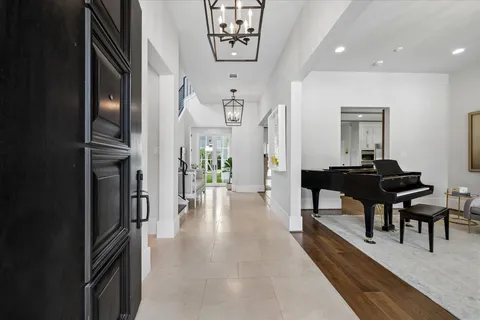 a dining room with furniture and a chandelier