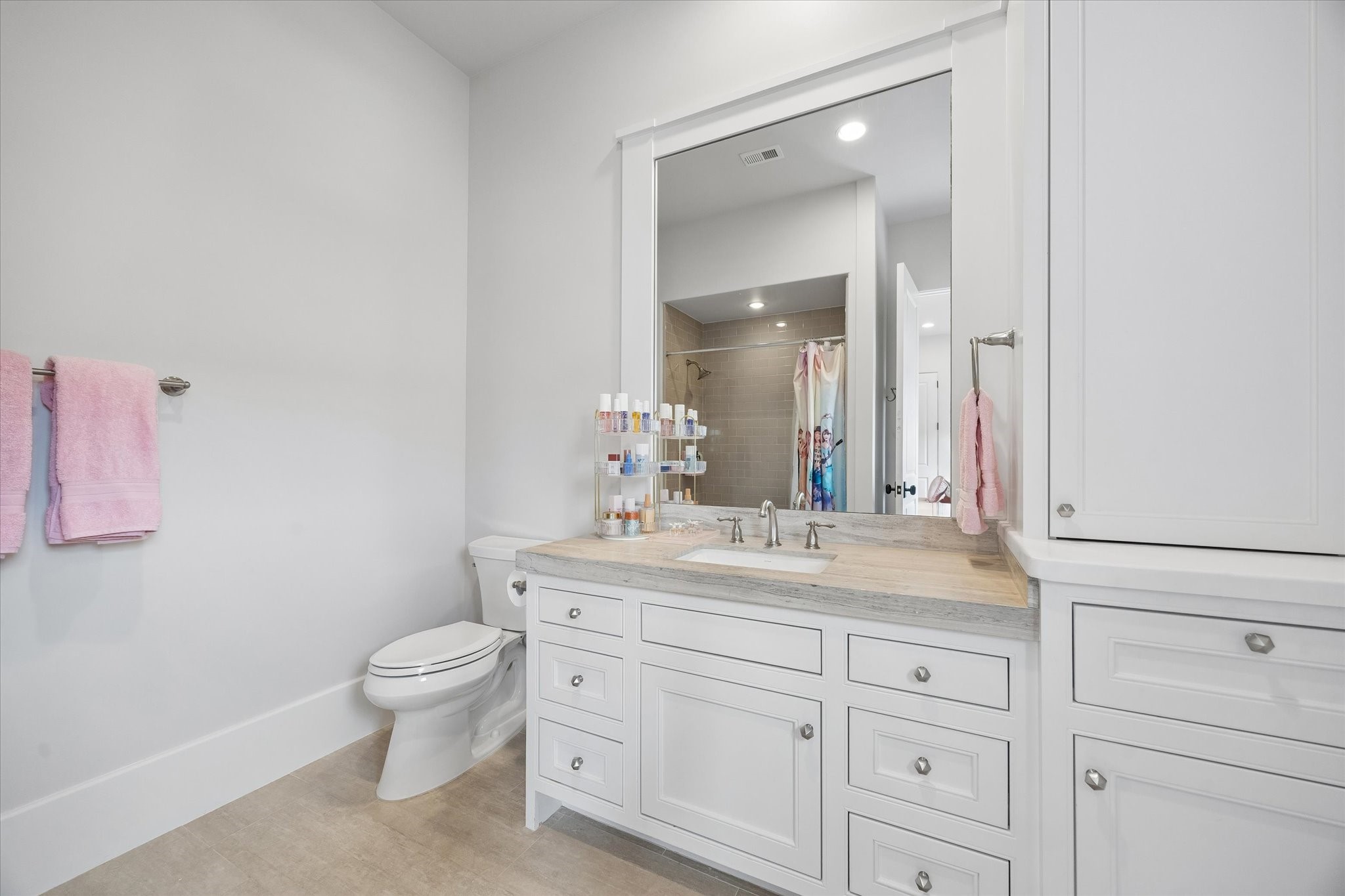 3615 Overbrook Lane Houston, TX 77027 - Photo 31 of 34 a bathroom with a granite countertop sink a toilet and a mirror