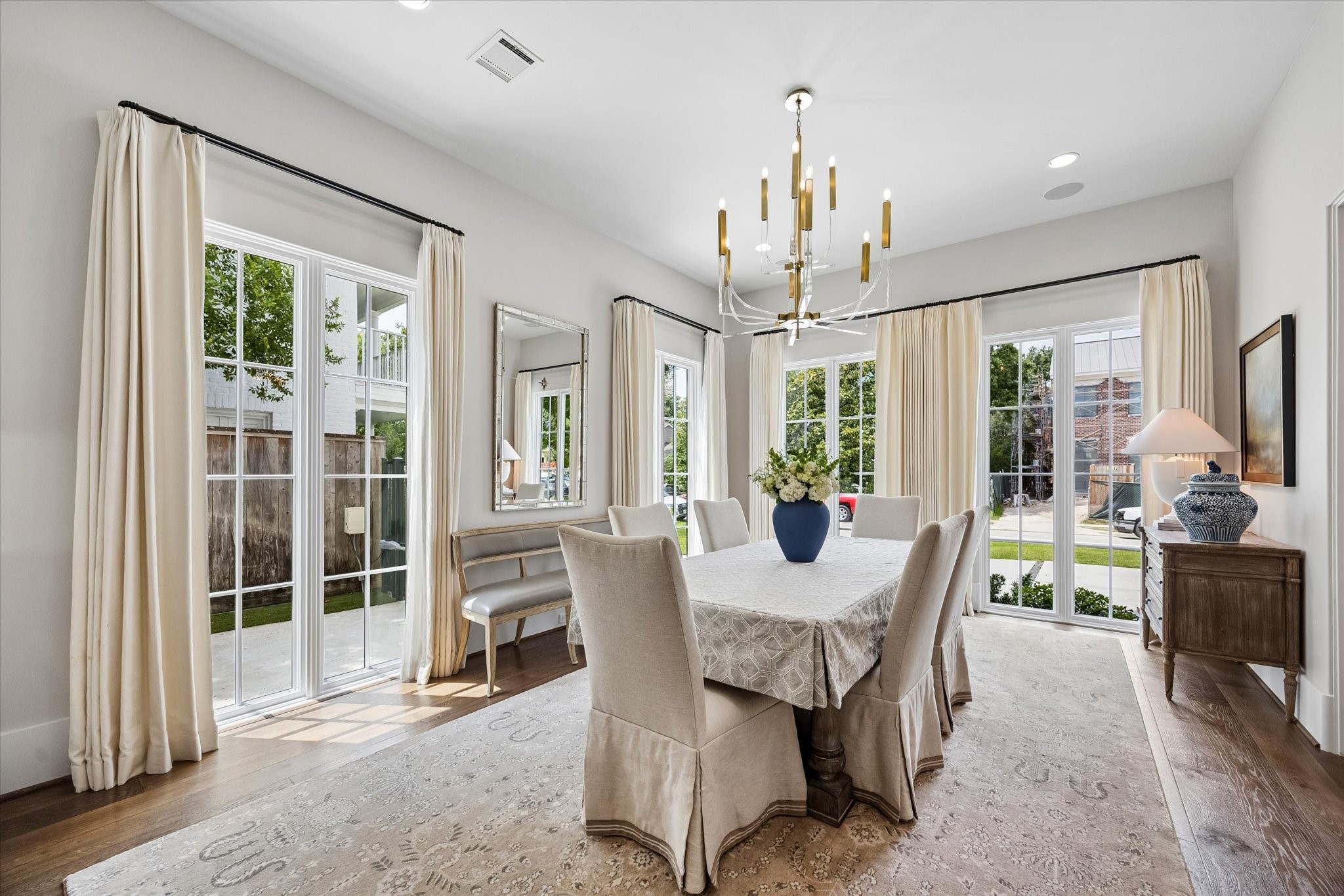 3615 Overbrook Lane Houston, TX 77027 - Photo 6 of 34 a view of a dining room with furniture large windows and wooden floor