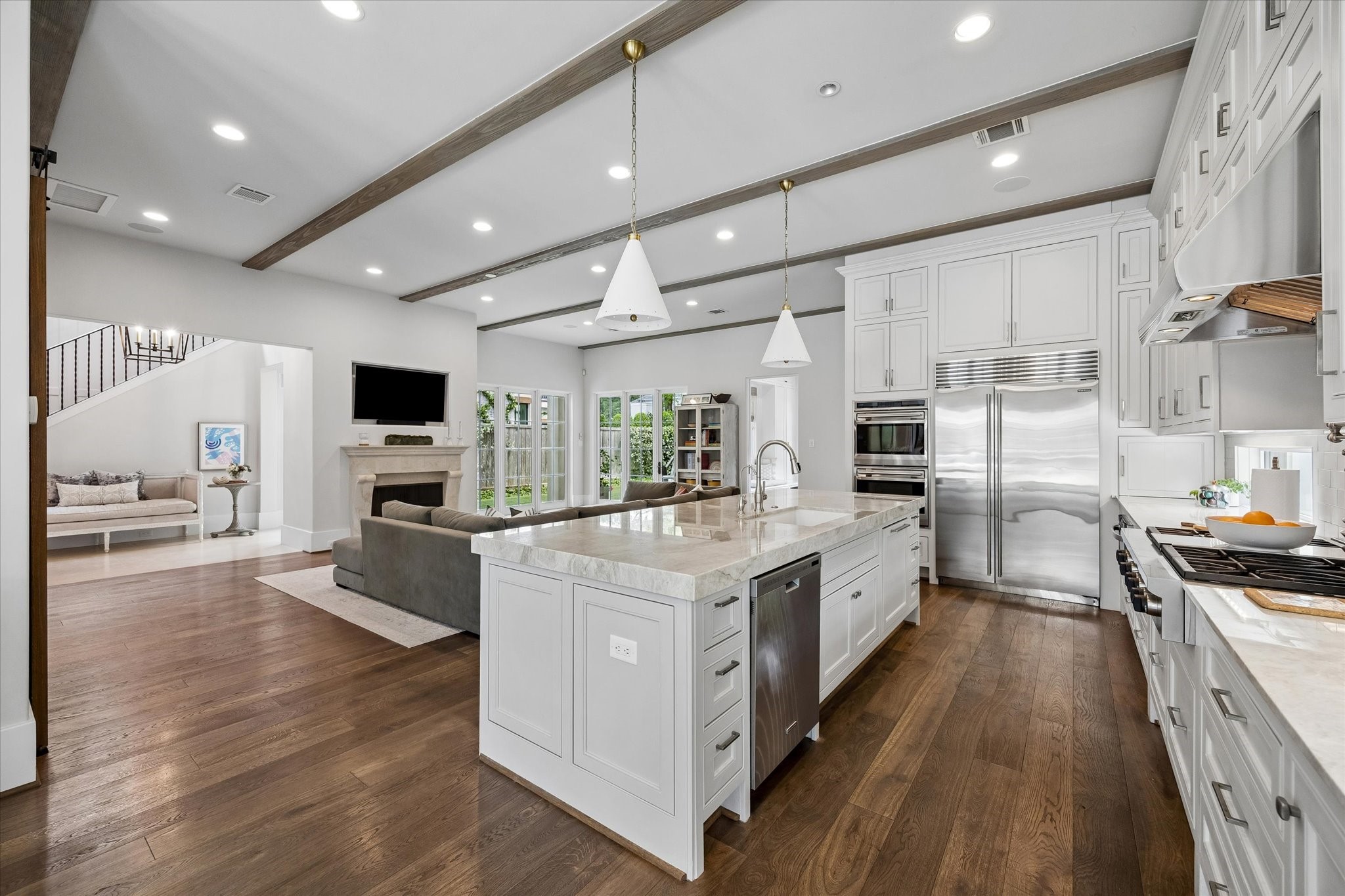 3615 Overbrook Lane Houston, TX 77027 - Photo 8 of 34 a large kitchen with stainless steel appliances and white cabinets