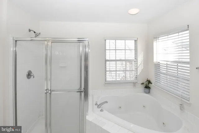 a white bath tub sitting next to a window
