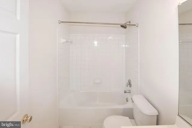 a bathroom with a shower and a toilet
