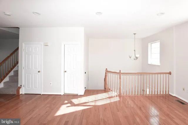 a view of a room with wooden floor