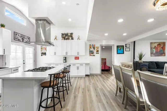 a living room with furniture a dining table and kitchen view