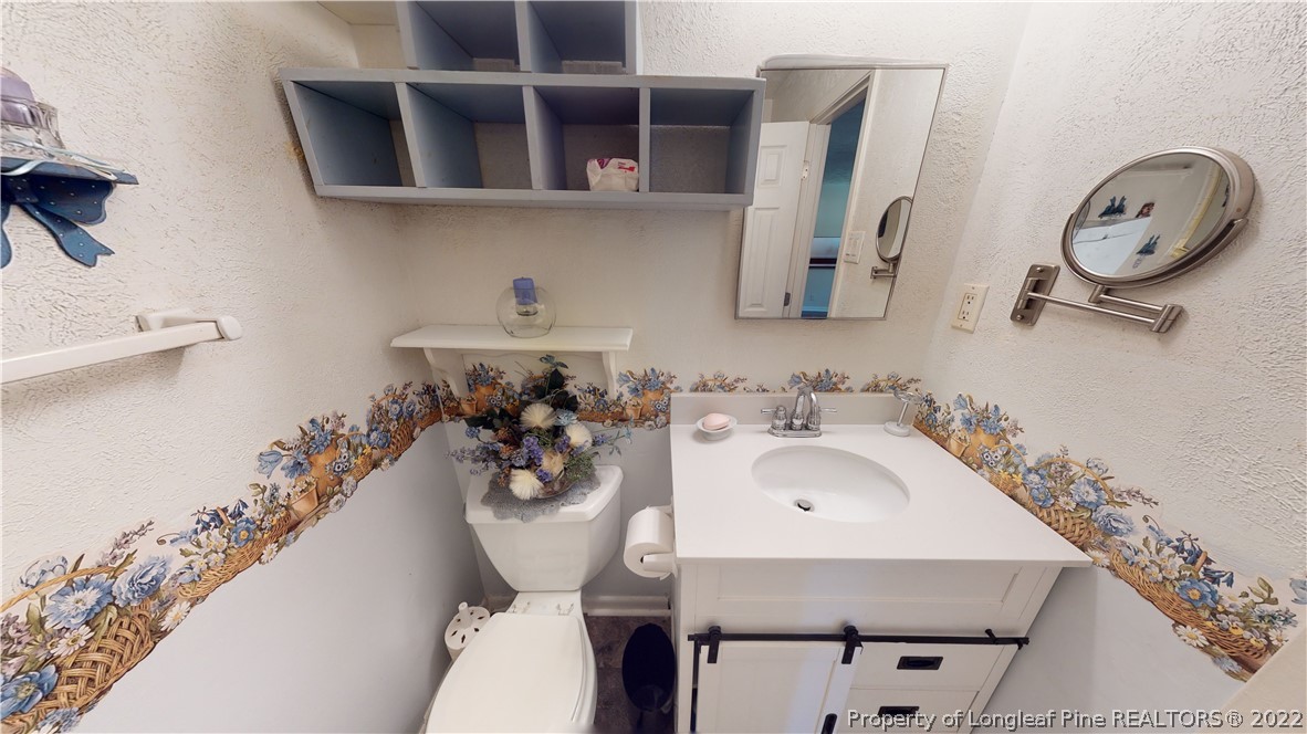 2678 County Line Road St. Pauls, NC 28384 - Photo 17 of 36 a bathroom with a sink and a mirror