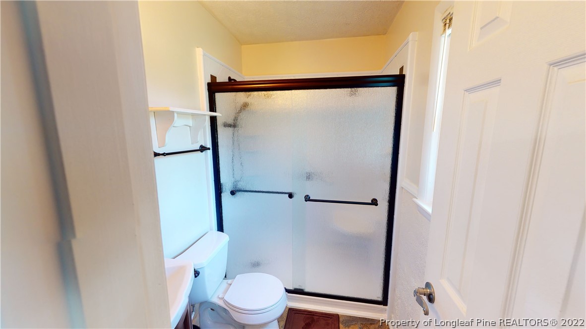 2678 County Line Road St. Pauls, NC 28384 - Photo 23 of 36 a white toilet sitting next to a shower