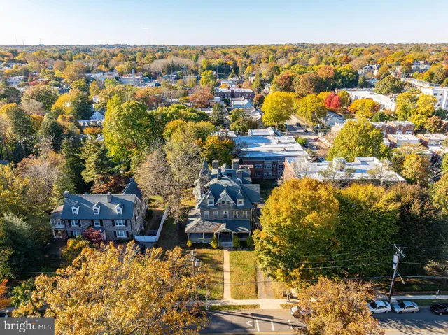 an aerial view of multiple houses with yard