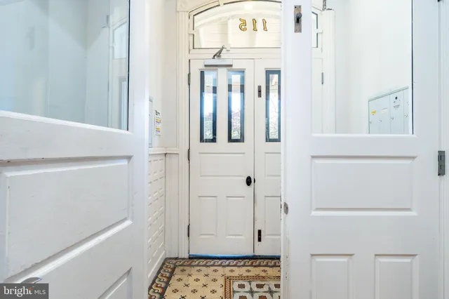 a view of an entryway with wooden floor