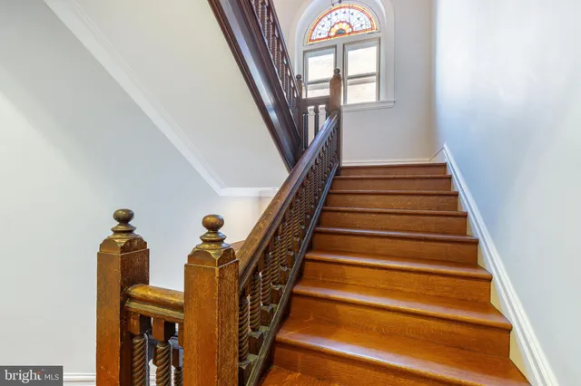 staircase with wooden floor and a window