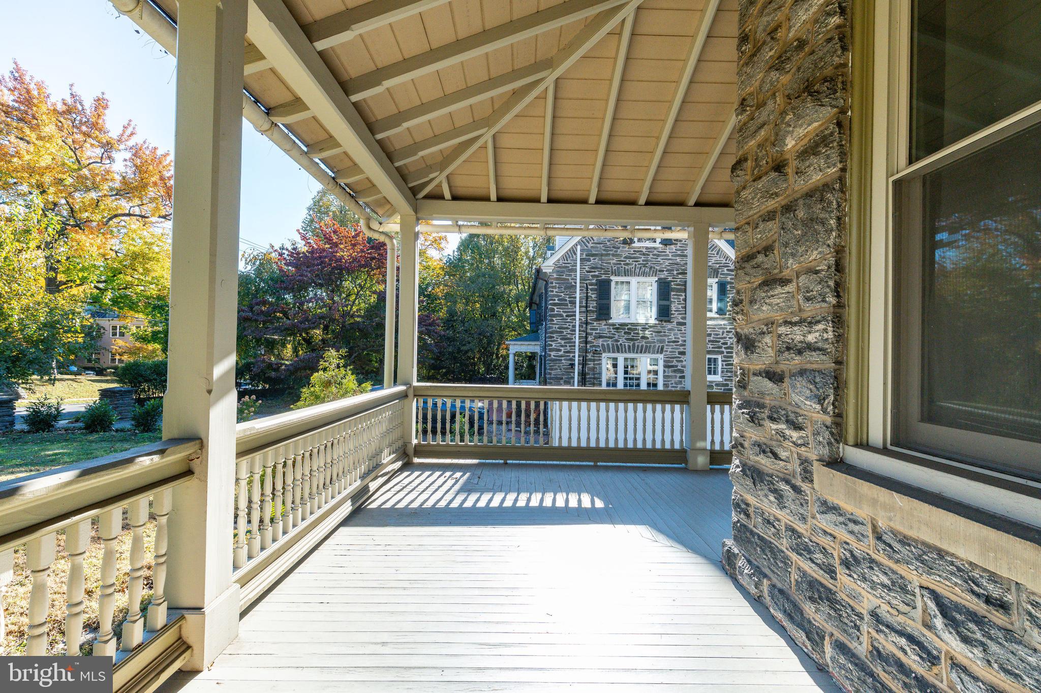 109-15 Carpenter Lane Philadelphia, PA 19119 - Photo 25 of 47 a view of a porch with a floor to ceiling window with wooden floor