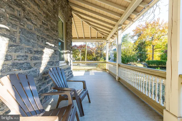 a view of porch with a table and chairs and wooden fence