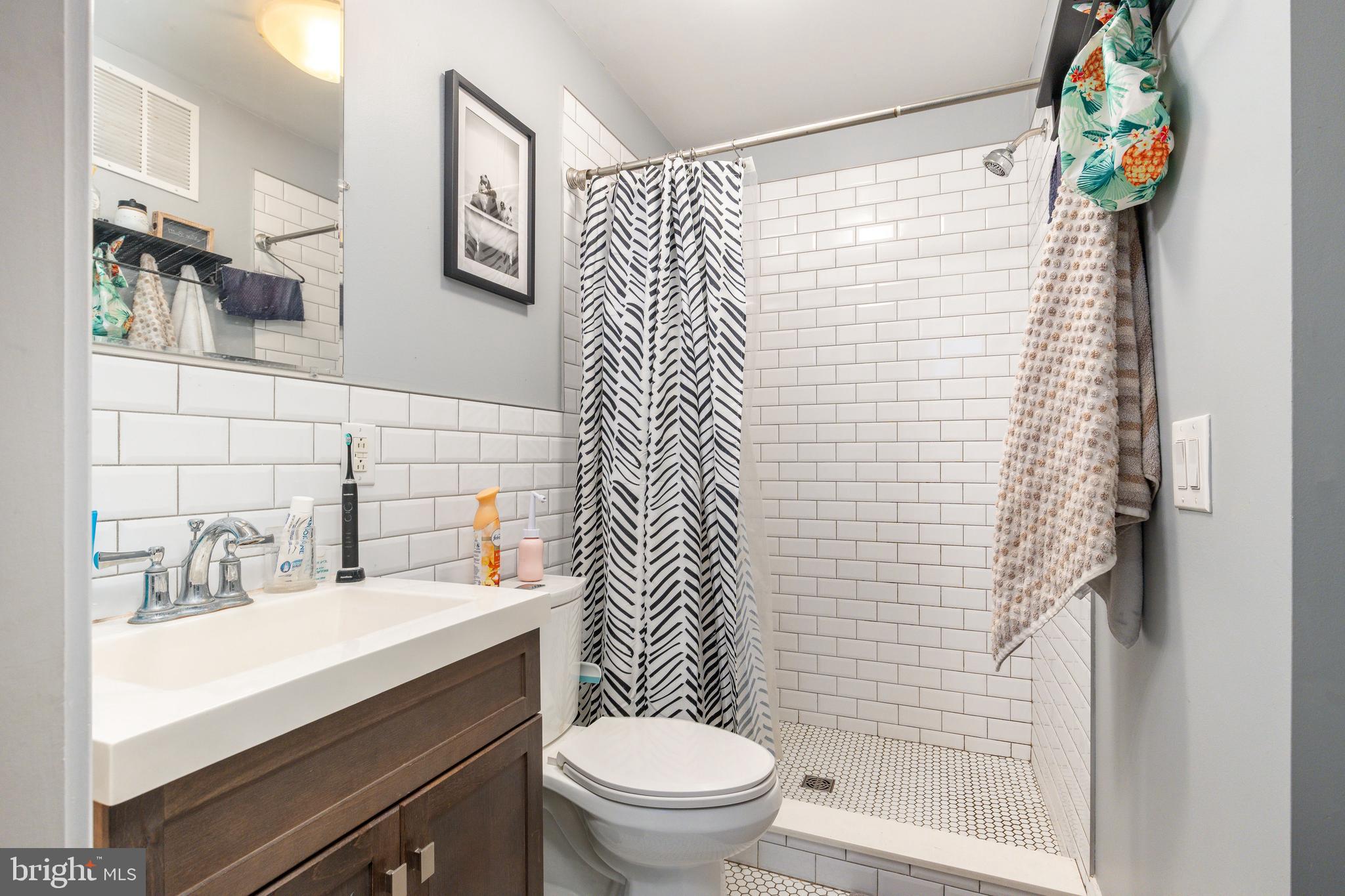 109-15 Carpenter Lane Philadelphia, PA 19119 - Photo 30 of 47 a bathroom with a sink toilet and shower