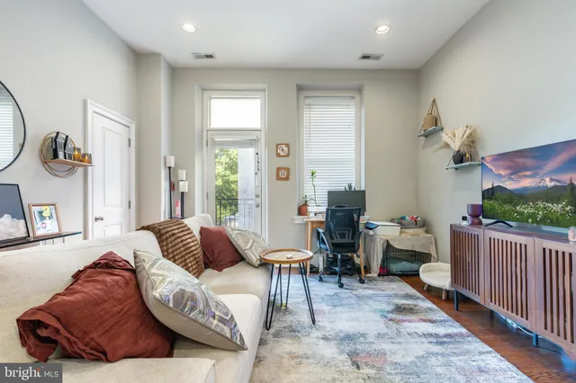 a kitchen with stainless steel appliances a stove a sink a refrigerator a microwave and cabinets