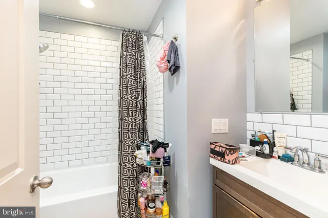 a balcony with chairs and a potted plant on a table