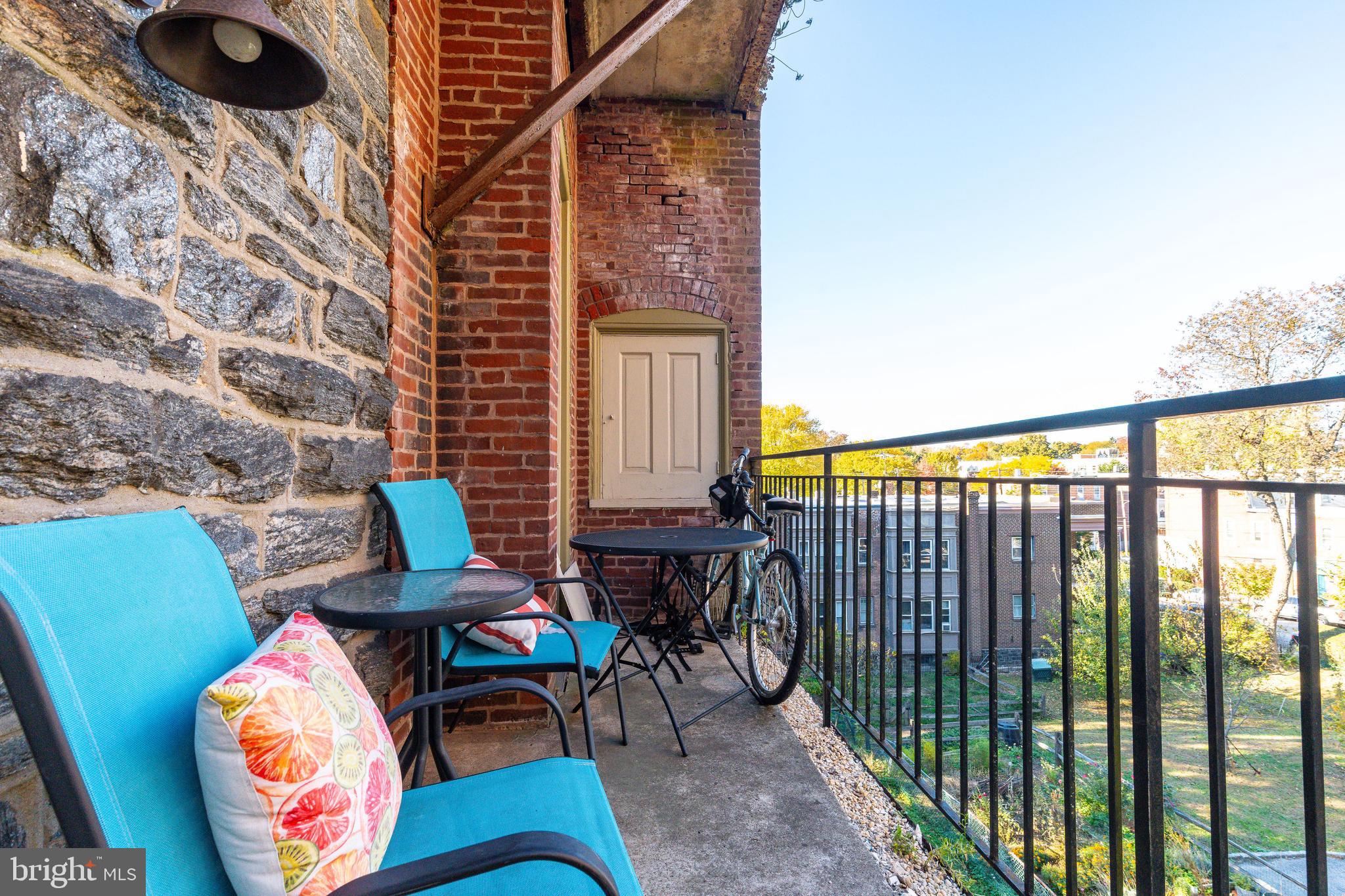 109-15 Carpenter Lane Philadelphia, PA 19119 - Photo 38 of 47 a balcony with chairs and a potted plant on a table