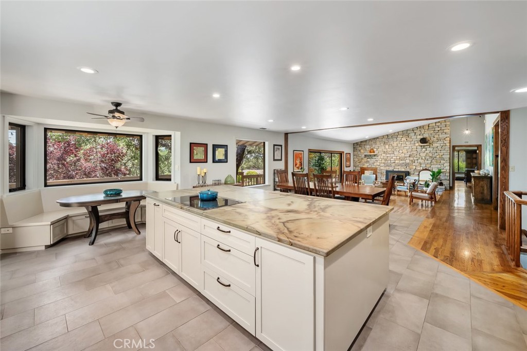 1105 Spanish Camp Road Paso Robles, CA 93446 - Photo 22 of 72 a living room with stainless steel appliances kitchen island granite countertop a large kitchen island a stove a sink a dining table and chairs with wooden floor