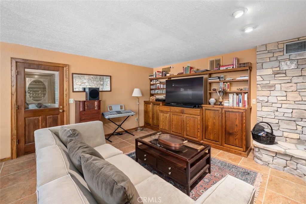 1105 Spanish Camp Road Paso Robles, CA 93446 - Photo 38 of 72 a living room with furniture and a flat screen tv