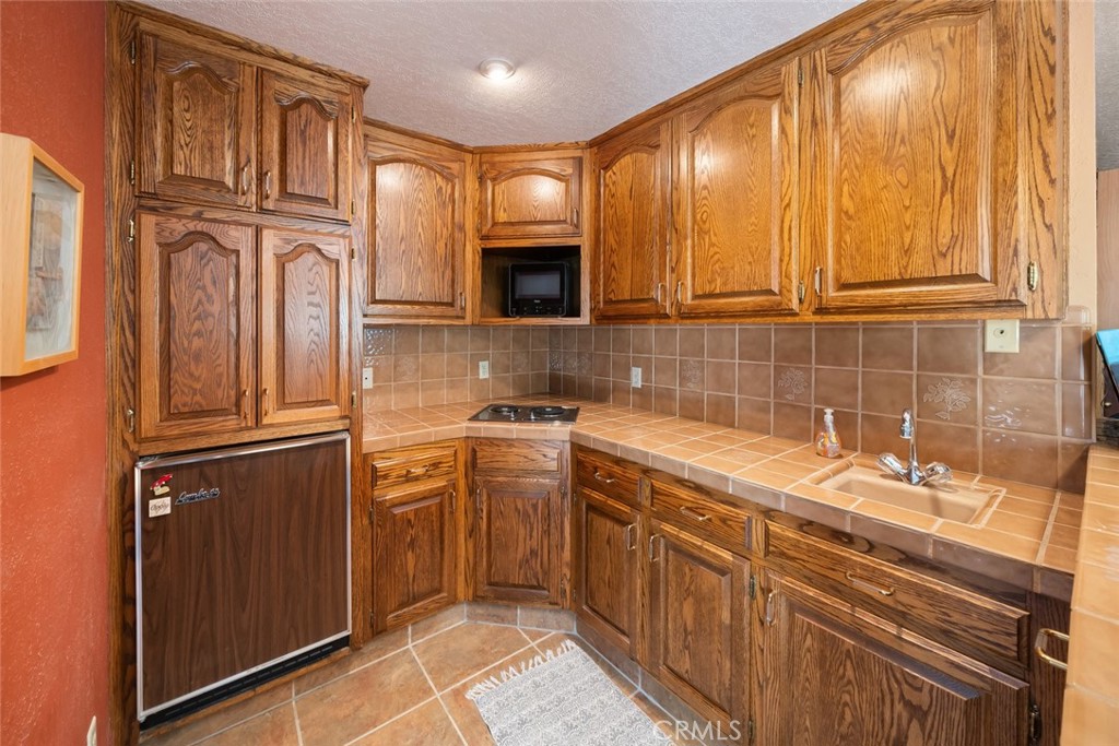 1105 Spanish Camp Road Paso Robles, CA 93446 - Photo 43 of 72 a kitchen with stainless steel appliances granite countertop a sink stove and cabinets