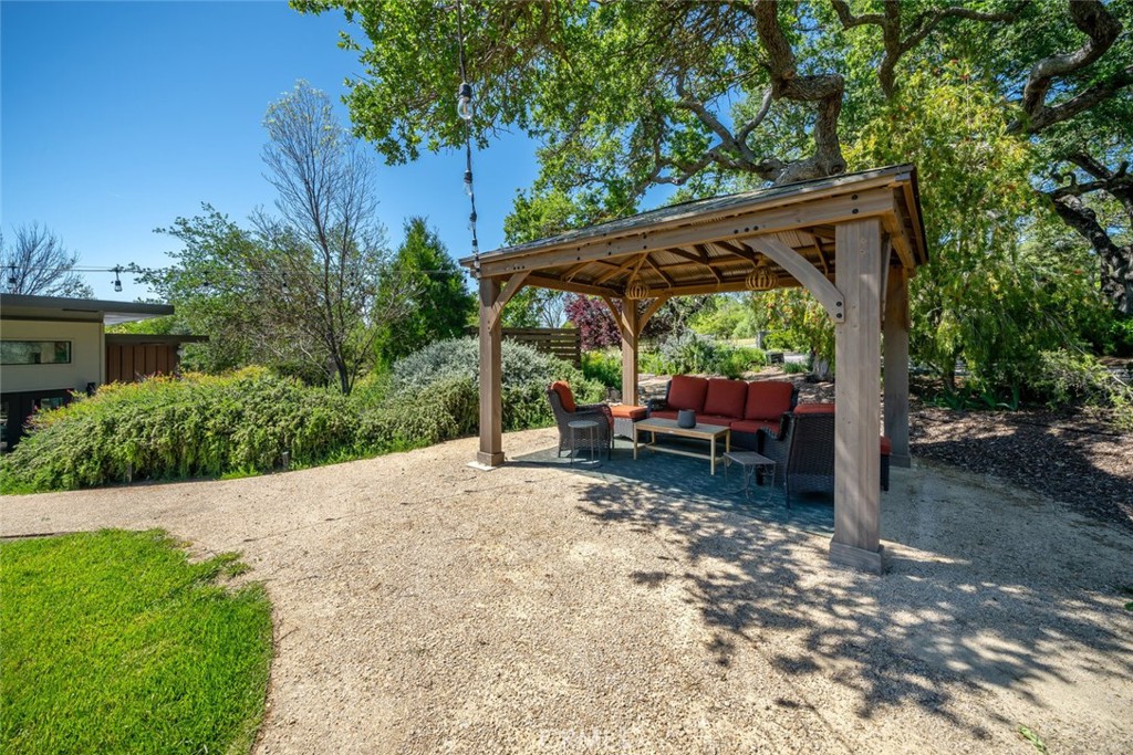 1105 Spanish Camp Road Paso Robles, CA 93446 - Photo 62 of 72 a view of backyard with a table and chair under an umbrella