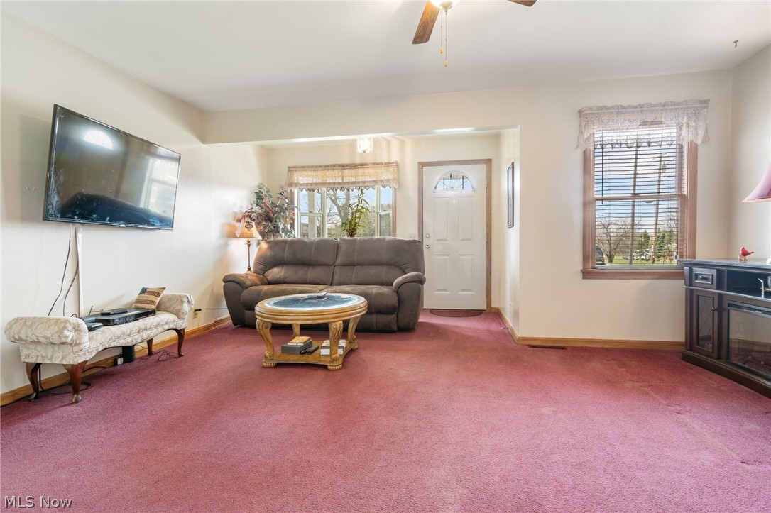 1850 South Sawburg Road Alliance, OH 44601 - Photo 8 of 39 Living room featuring carpet flooring, ceiling fan/light, and bay window