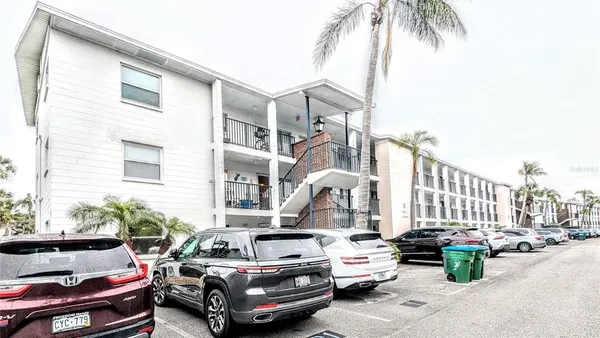 a couple of cars parked in front of a house