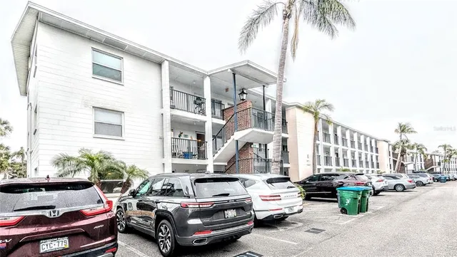 a couple of cars parked in front of a house