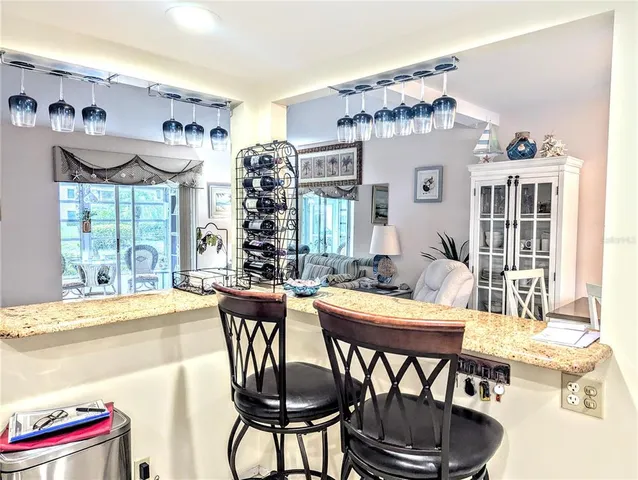 a dining room with furniture a chandelier and window