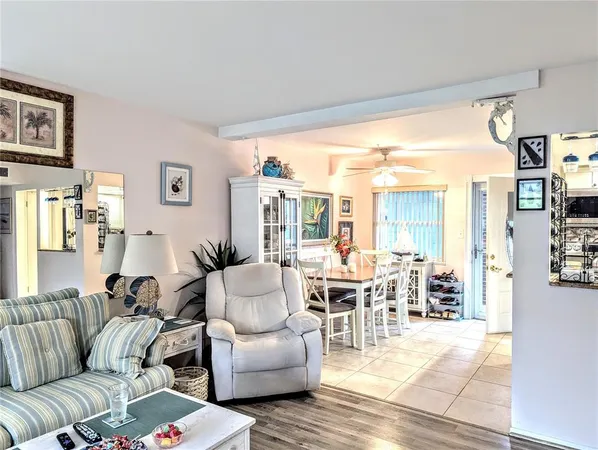 a living room with furniture dining area and a large window