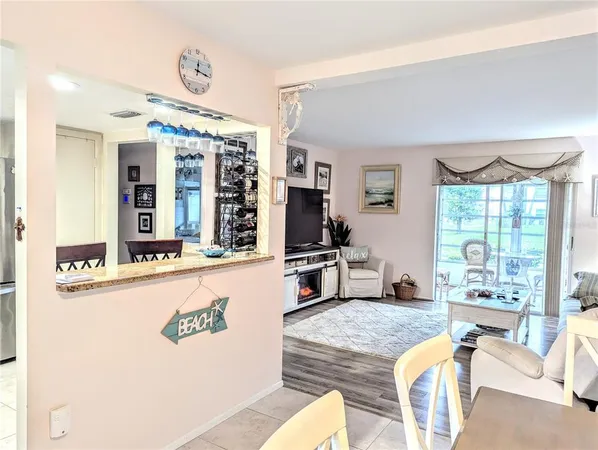 a living room with furniture large window and flat screen tv